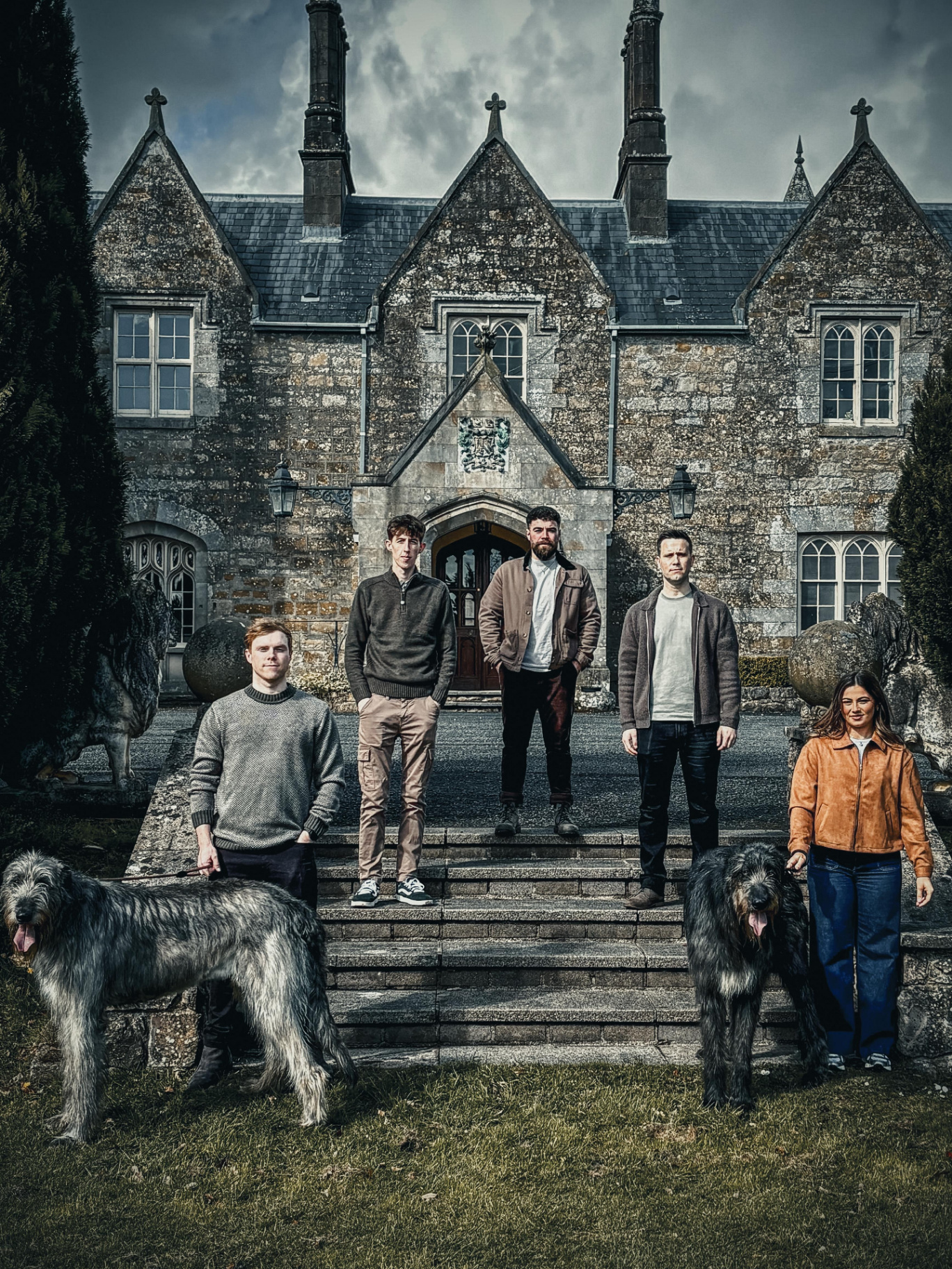Wolfhound band portrait at a Gothic manor with two Irish wolfhounds